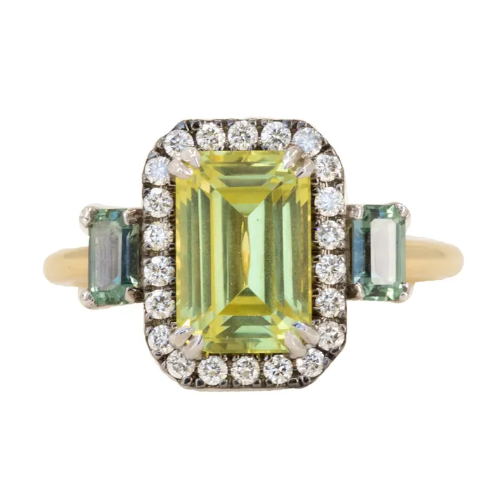 262ct Emerald Cut Nigerian Sapphire and Montana Sapphire Low Profile Scallop Cut Three Stone Ring with Antiqued Diamond Halo in 18k Yellow Gold Anueva Jewelry Rings 262ct Emerald Cut Nigerian Sapphire and Montana Sapphire Low Profile Scallop Cut Three Stone Ring with Antiqued Diamond Halo in 18k Yellow Gold Anueva Jewelry Rings
