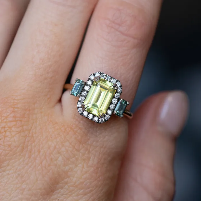 262ct Emerald Cut Nigerian Sapphire and Montana Sapphire Low Profile Scallop Cut Three Stone Ring with Antiqued Diamond Halo in 18k Yellow Gold Anueva Jewelry Rings