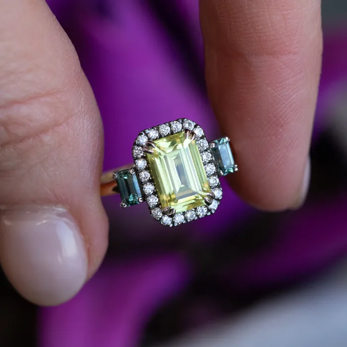 262ct Emerald Cut Nigerian Sapphire and Montana Sapphire Low Profile Scallop Cut Three Stone Ring with Antiqued Diamond Halo in 18k Yellow Gold Anueva Jewelry Rings